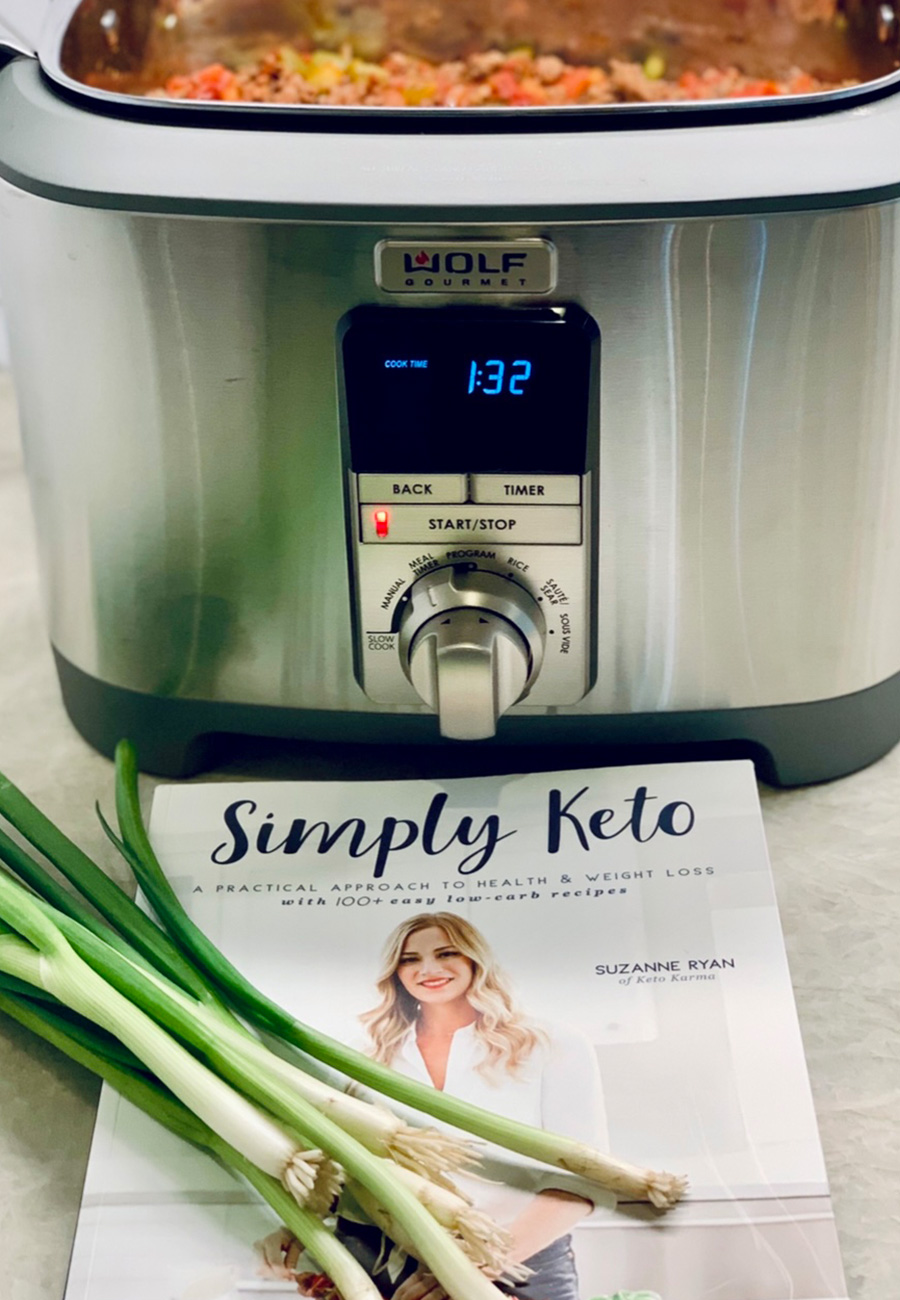 Metallic slow cooker with Simply Keto book in front