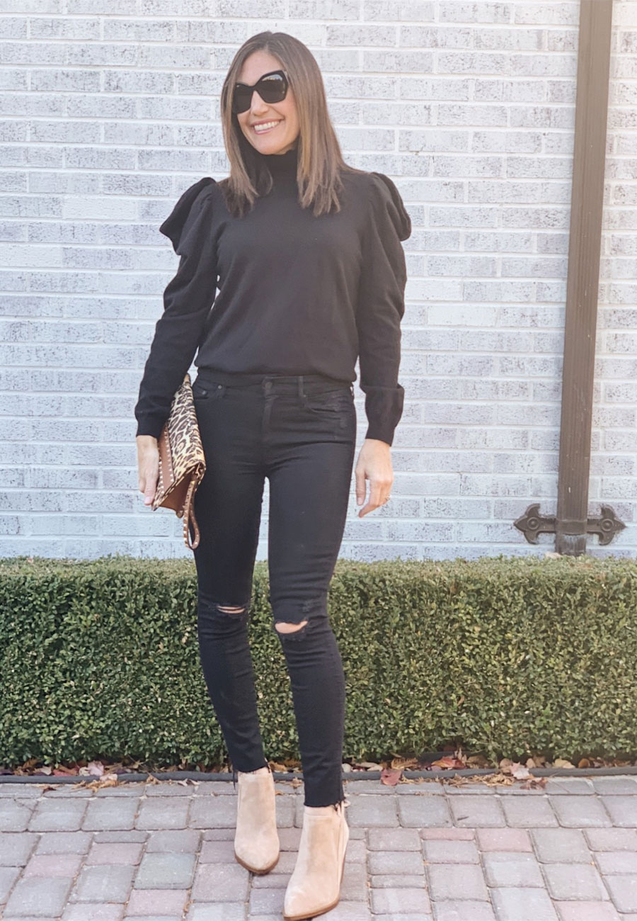 Photo of Alysia outside in black outfit with cheetah purse