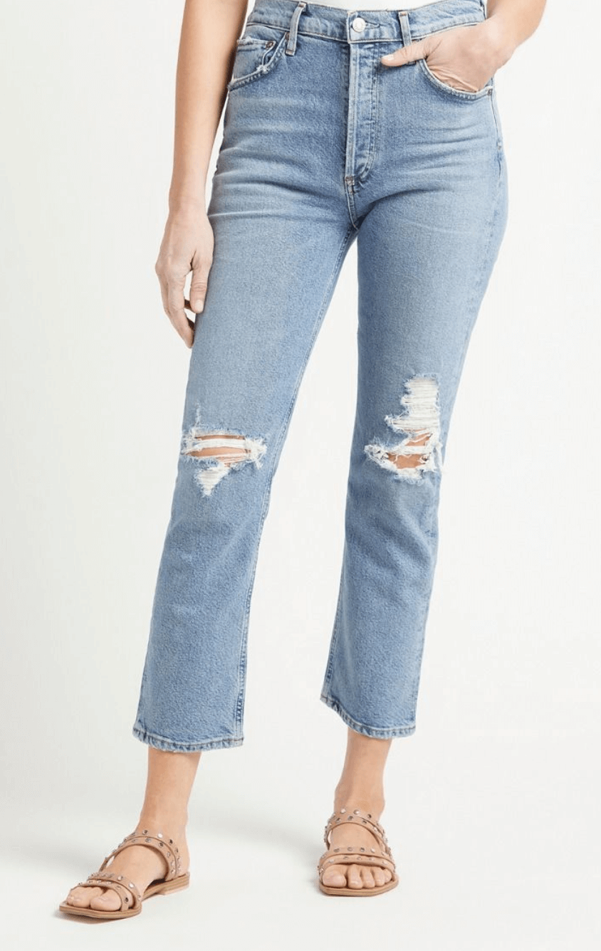 Model wearing light wash distressed jeans