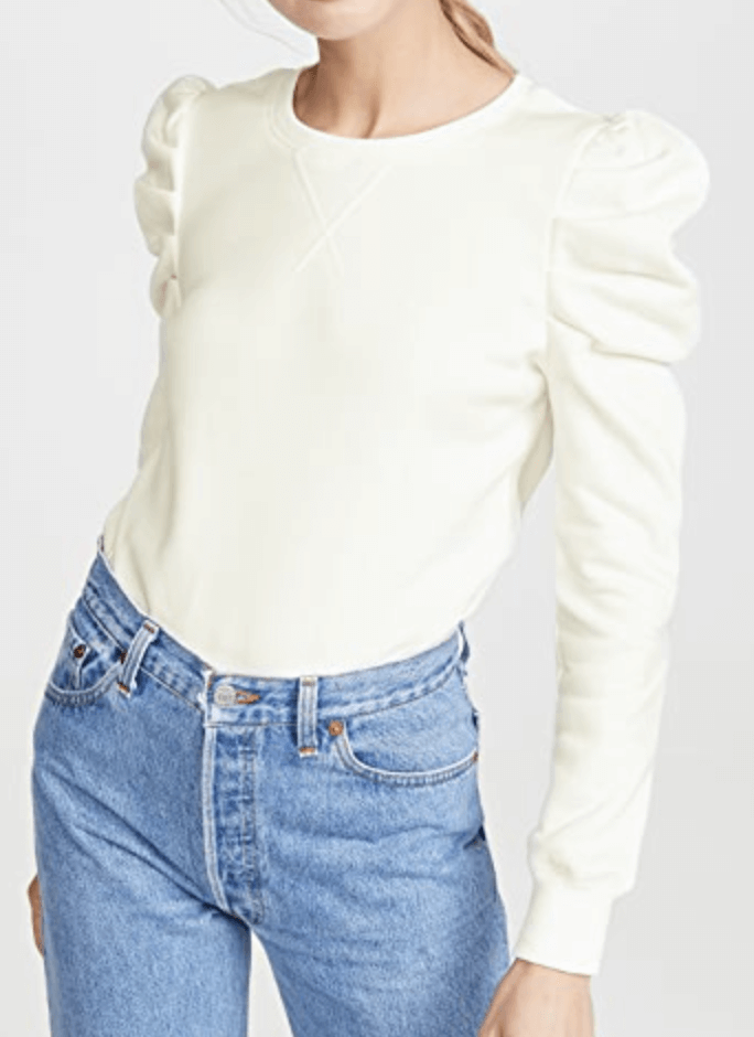 Model wearing white longsleeve shirt with puffy sleeves