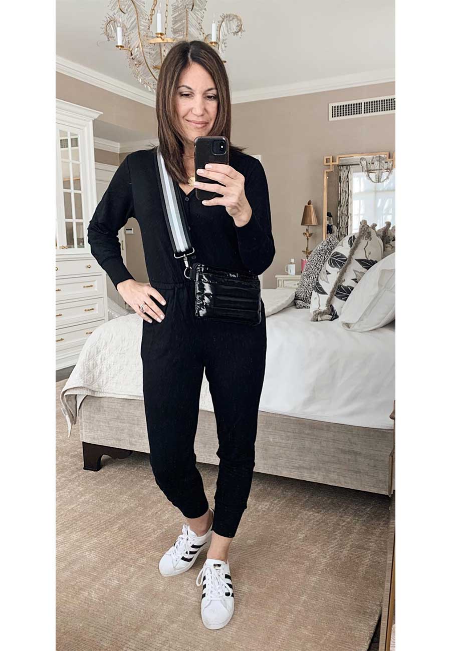 Alysia wearing black top and pants with white and black sneakers